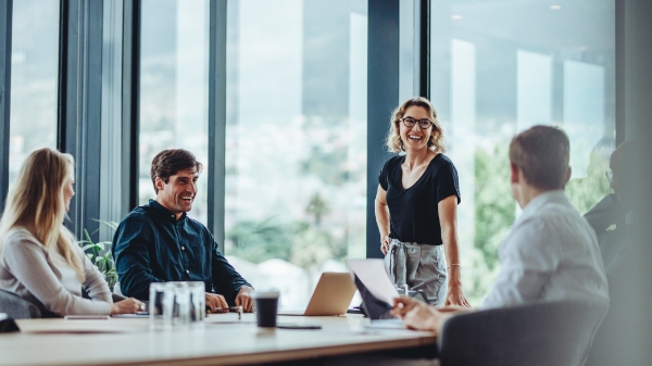 Four people in a conference room having a meeting